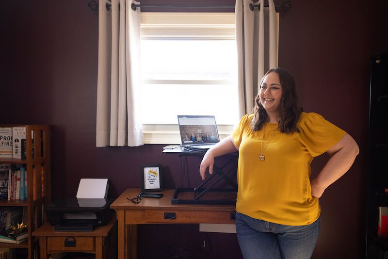 Lindsay Darby, CMA, standing by desk in home office